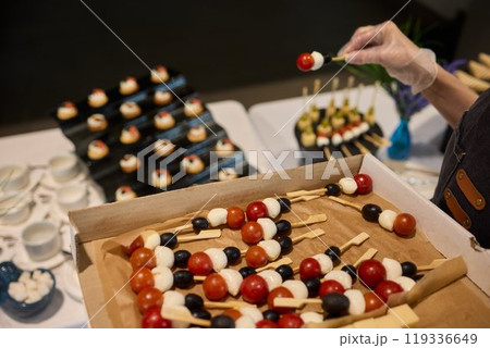 A Vibrantly Colorful Appetizer Platter Featuring Skewers and a Variety of Fresh Ingredients 119336649