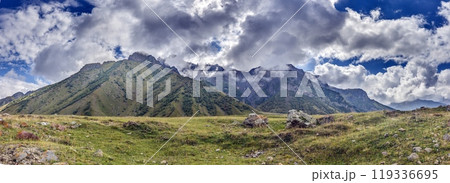 Scenic view of the Cross Pass in Georgia, showcasing lush green mountains and a winding valley Scenic view of the Cross Pass in Georgia, showcasing lush green mountains and a winding valley 119336695