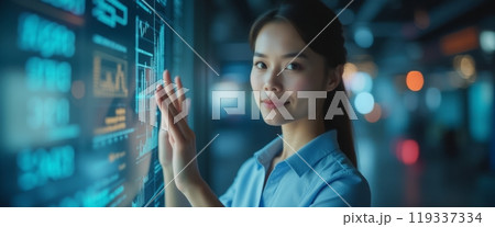 A young woman interacts with a futuristic digital display in a dimly lit setting. The image conveys technology, innovation, and modern interaction. A young woman interacts with a futuristic digital display in a dimly lit setting. The image conveys technology, innovation, and modern interaction. 119337334