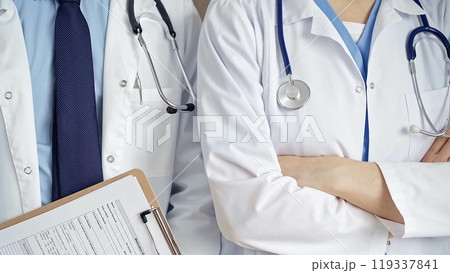 Professional healthcare team in uniform. Two doctors with stethoscopes are standing straight with arms crossed. Medicine concept 119337841