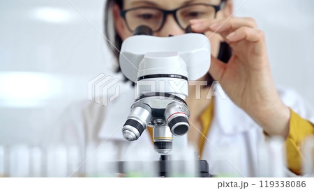 Woman scientist using microscope in laboratory. Microbiology science concept Woman scientist using microscope in laboratory. Microbiology science concept 119338086