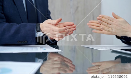 Unrecognizable business people shaking hands and clapping over g 119338091