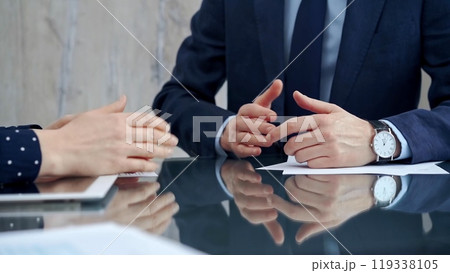 Unrecognizable business people shaking hands and clapping over glass table after contract signing in office. Agreement and handshake themes Unrecognizable business people shaking hands and clapping over glass table after contract signing in office. Agreement and handshake themes 119338105