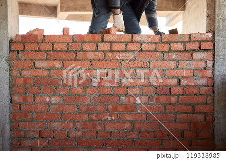 professional construction worker laying bricks and building barbecue in industrial site. Detail of hand adjusting bricks professional construction worker laying bricks and building barbecue in industrial site. Detail of hand adjusting bricks 119338985