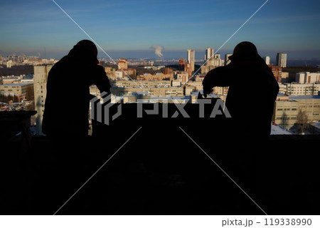 professional construction worker laying bricks and building barbecue in industrial site. Detail of hand adjusting bricks 119338990