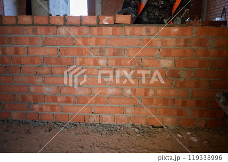professional construction worker laying bricks and building barbecue in industrial site. Detail of hand adjusting bricks professional construction worker laying bricks and building barbecue in industrial site. Detail of hand adjusting bricks 119338996