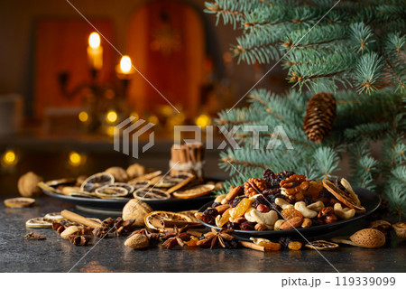 Christmas still-life with spruce branches, dried fruits, and spices. Christmas still-life with spruce branches, dried fruits, and spices. 119339099