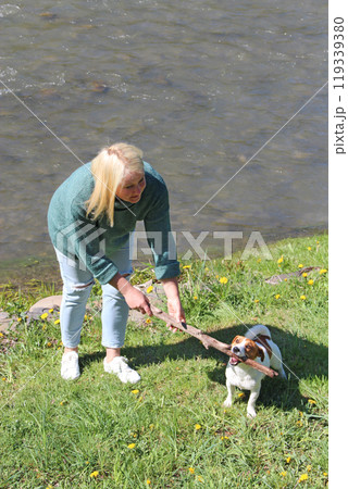 Woman having fun with their Jack Russell Terrier dog. Dog training 119339380