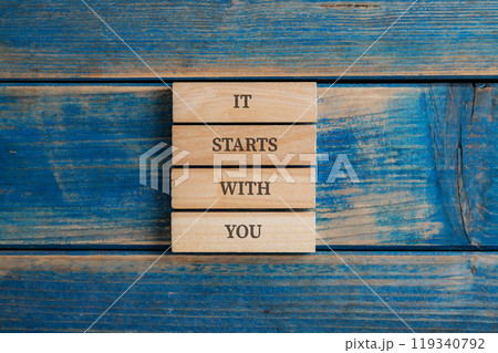 t starts with you sign written on four stacked wooden pegs t starts with you sign written on four stacked wooden pegs 119340792