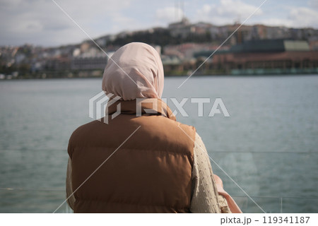 Unhappy girl standing at bench . Unhappy girl standing at bench . 119341187