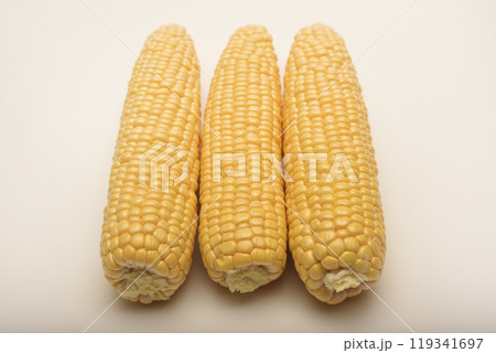 Three peeled ears of corn on a white background. A printed cob. Ripe delicious corn. 119341697
