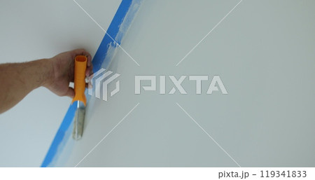 Man worker hand painting the wall inside the house and building. Builder, tools, apartment renovation. 119341833