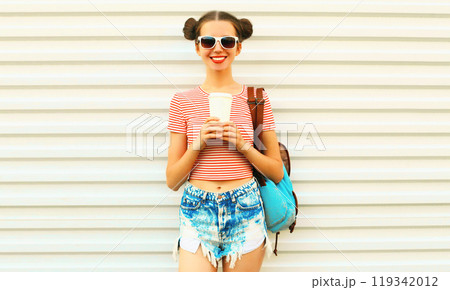 Portrait of happy smiling young woman drinking coffee with cool hairstyle on white background Portrait of happy smiling young woman drinking coffee with cool hairstyle on white background 119342012
