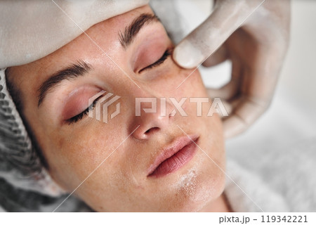 Aesthetic treatment session for a woman at a beauty clinic during daytime Aesthetic treatment session for a woman at a beauty clinic during daytime 119342221