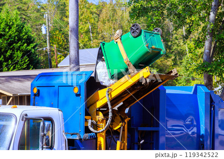 Removal of garbage by municipal cleaning services by loading mixed household waste into garbage trucks Removal of garbage by municipal cleaning services by loading mixed household waste into garbage trucks 119342522
