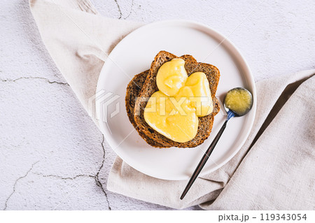 Close up of sandwiches on grain bread with honey butter on a plate on the table top view 119343054
