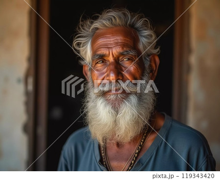 An elderly man from India exudes joy with a warm smile and twinkling eyes. His gray hair and beard reflect the wisdom of his years, showcasing a life rich in experiences. Generative AI 119343420