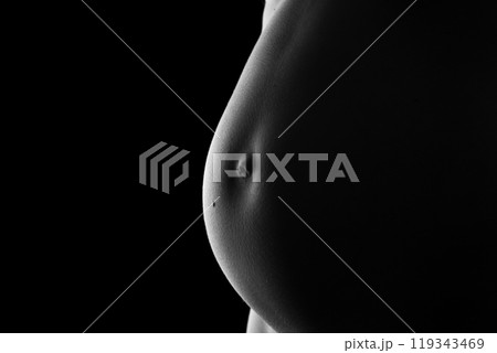 Belly of a very pregnant woman 119343469