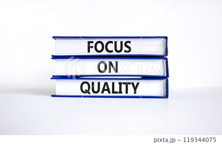 Focus on quality symbol. Concept words Focus on quality on books on beautiful white table white background. Business, focus on quality concept. Copy space. Focus on quality symbol. Concept words Focus on quality on books on beautiful white table white background. Business, focus on quality concept. Copy space. 119344075