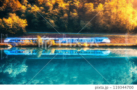 Beautiful blue modern high speed train and river in mountains 119344700