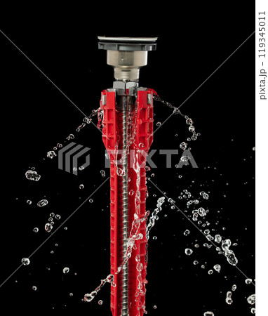 Water leak under sink on Nut Bolt stainless steel. Drain sink leak water from pipe plumbing in bathroom and repair by flume wrench tools as water splash drop. Black background isolated Water leak under sink on Nut Bolt stainless steel. Drain sink leak water from pipe plumbing in bathroom and repair by flume wrench tools as water splash drop. Black background isolated 119345011