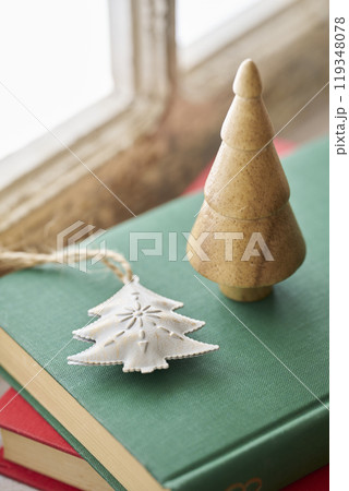 アンティークな窓辺に置かれた古い洋書とクリスマス小物 アンティークな窓辺に置かれた古い洋書とクリスマス小物 119348078