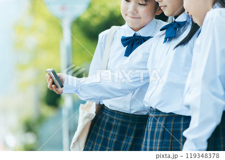 バス停でスマホをみる女子学生 バス停でスマホをみる女子学生 119348378