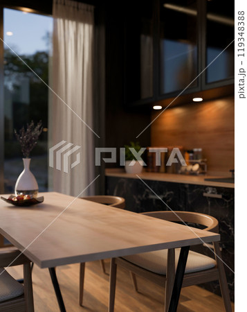 A close-up of a hardwood dining table with armchairs in a contemporary, luxurious black kitchen. 119348388