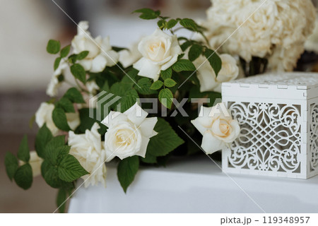A white box with a floral design sits on a table 119348957