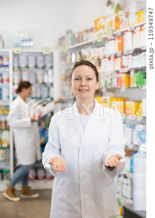 Adult female pharmacist in uniform posing in pharmacy 119349747