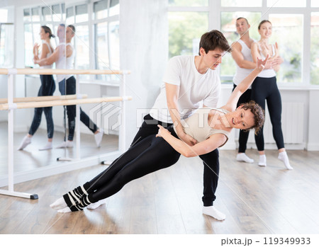 Young guy and adult woman rehearsing pair ballet Young guy and adult woman rehearsing pair ballet 119349933