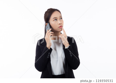 Portrait young asian businesswoman in suit thinking while talking on smartphone with doubt isolated. 119350531