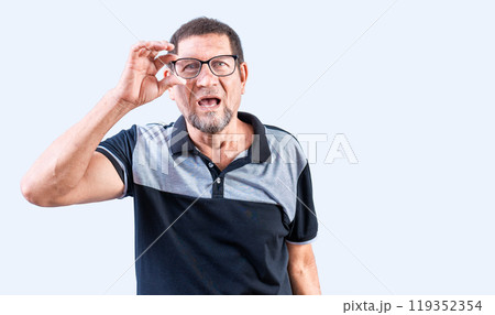 Amazed senior man taking off glasses isolated. Surprised senior man taking off glasses looking at camera Amazed senior man taking off glasses isolated. Surprised senior man taking off glasses looking at camera 119352354