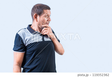 Surprised senior people with open mouths looking to the side. Astonished old man looking at a promotion aside, holding his chin Surprised senior people with open mouths looking to the side. Astonished old man looking at a promotion aside, holding his chin 119352362