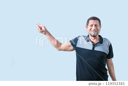 Smiling senior man pointing to the side isolated. Happy senior man pointing at an advertising space isolated 119352381