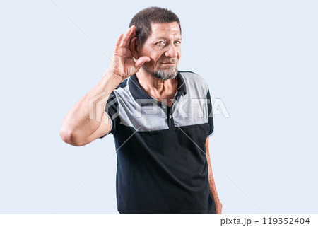 Senior man with hand on ear hearing a rumor isolated. Old man listening to a rumor isolated Senior man with hand on ear hearing a rumor isolated. Old man listening to a rumor isolated 119352404