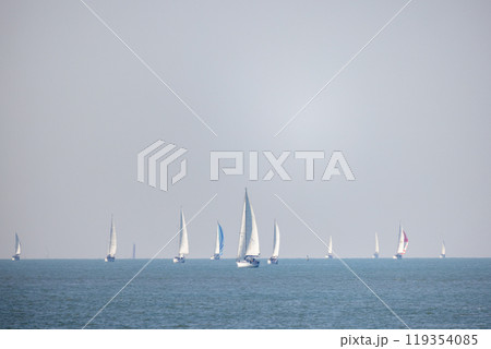 Sailing Vessels Gracefully Gliding on the Calm and Tranquil Ocean Waters at Daylight Sailing Vessels Gracefully Gliding on the Calm and Tranquil Ocean Waters at Daylight 119354085
