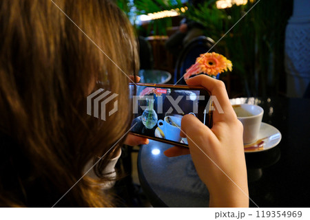 Shooting a coffee blog with a heart and beautiful flowers on your mobile phone 119354969