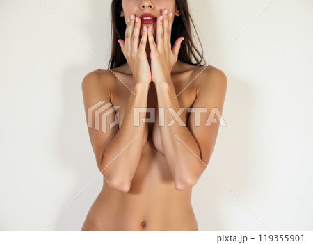 Naked young woman covering her breasts with her hands on a white background. The concept of breast treatment and cosmetology. Generatine AI 119355901