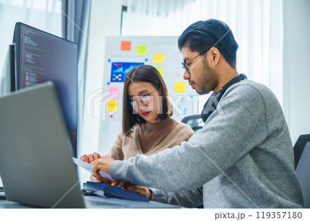 asian and Indian Developer team discussion feedback analysis coding data with software computer at office 119357180