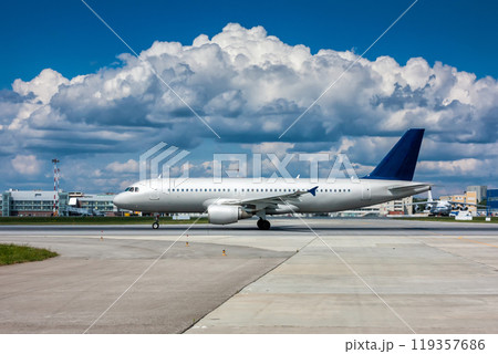 Passenger airplane on the runway with a beautiful textured sky 119357686