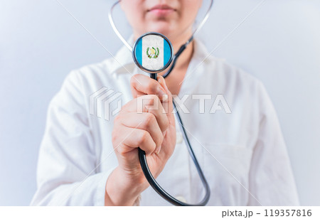 Female doctor holding stethoscope with Guatemala flag. Guatemalan Health and Care concept 119357816