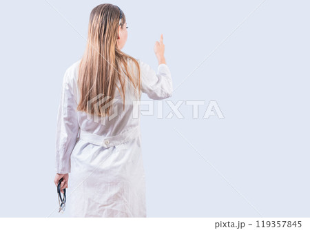 Rear view of female doctor pointing isolated. Young female doctor from behind pointing finger isolated Rear view of female doctor pointing isolated. Young female doctor from behind pointing finger isolated 119357845