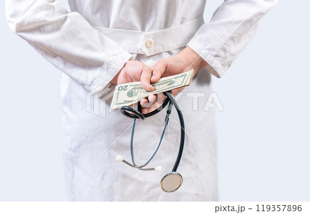 Corrupt doctor hiding money back, Dishonest doctor hiding money. Medical corruption and bribery concept Corrupt doctor hiding money back, Dishonest doctor hiding money. Medical corruption and bribery concept 119357896