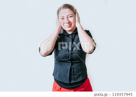 Displeased girl in glasses covering her ears isolated. Frustrated woman covering her ears tightly 119357945
