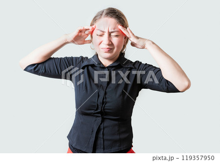 Young woman with headache isolated. Portrait of girl suffering from migraine on isolated background. Headache concept Young woman with headache isolated. Portrait of girl suffering from migraine on isolated background. Headache concept 119357950
