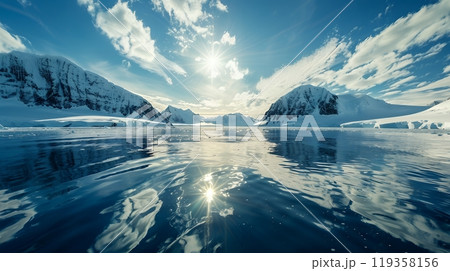 Sunrise over mountains covered in snow. Pieces of ice frozen in the cold waters of the ocean. Melting glacier. Illustration of climate change. Sunrise over mountains covered in snow. Pieces of ice frozen in the cold waters of the ocean. Melting glacier. Illustration of climate change. 119358156