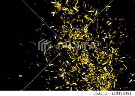 Many Party glitter scatter in many group. Golden Confetti Foil fall splashing in air. Gold Confetti Foil explosion flying, abstract cloud fly. Black background isolated element freeze 119358451