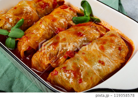 Stuffed cabbage rolls with minced meat, in tomato sauce, top view, without people, in the spotlight. Stuffed cabbage rolls with minced meat, in tomato sauce, top view, without people, in the spotlight. 119358578