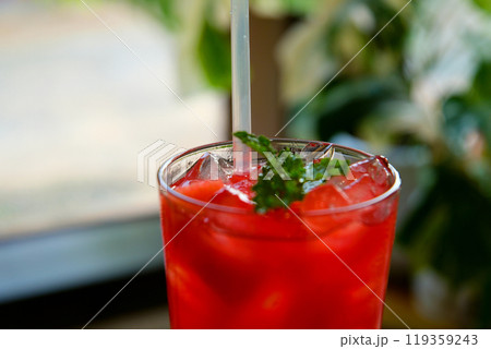 Fresh watermelon juice or smoothie in glasses with watermelon pieces on pink background. Refreshing summer drink Fresh watermelon juice or smoothie in glasses with watermelon pieces on pink background. Refreshing summer drink 119359243